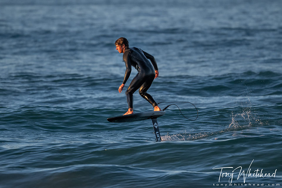 Photo of hydrofoil board rider in the last rays of sun