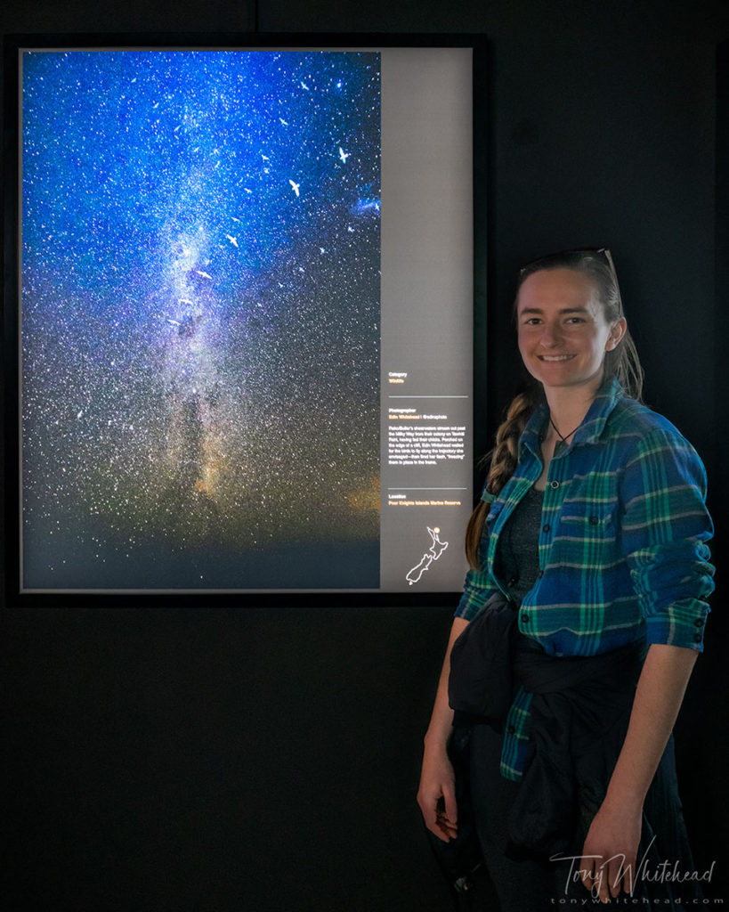 Photo of Edin with her finalist image of Bullers Shearwaters against the Milky Way